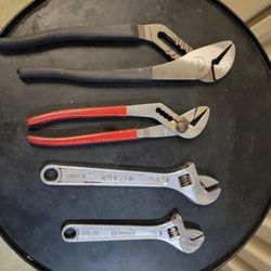 Two Crescent Wrenches And Two Plyers