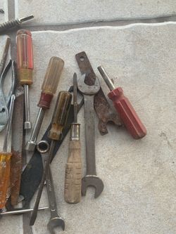 Bin of screw drivers and different sized wrench’s