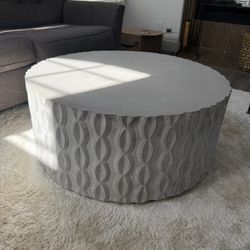 Stylish round coffee table with a unique patterned design. - cement 