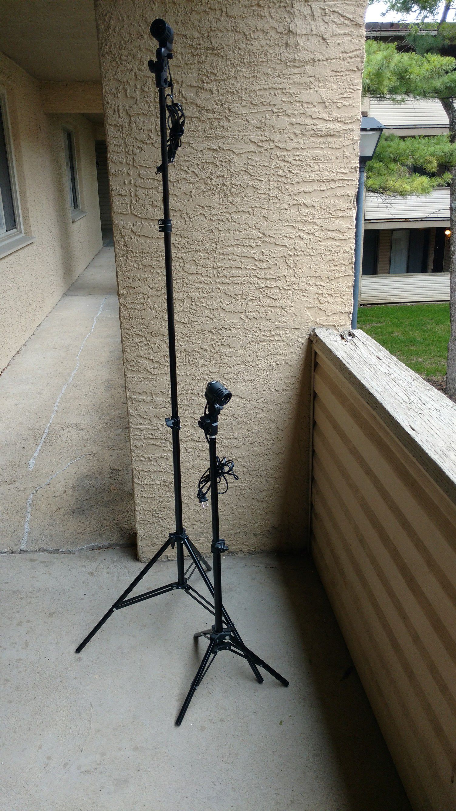 Two photo light stands with light fixtures for portraits
