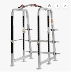 Hoist squat cage with Rogue barbell and bumper plates!