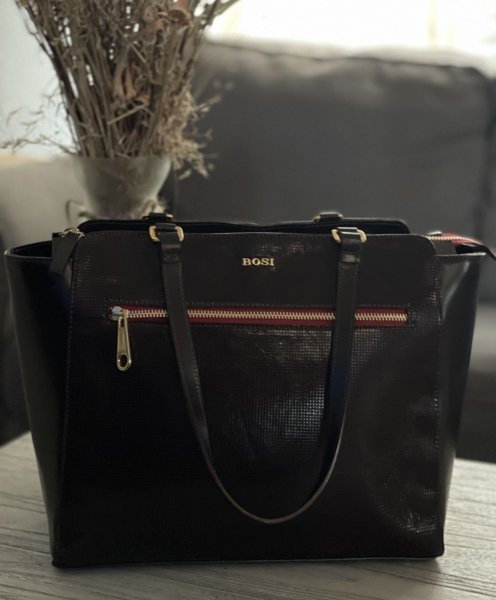 This Vintage BOSI Tote is a Stunning Addition to any Wardrobe. The Deep Burgundy\Merlot Red Leather Exterior is Accented with Studs and Gold Hardware,