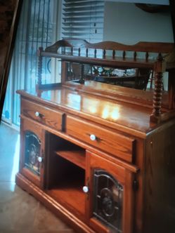 A very nice oak , dry bar , a mirror in the back and handles for your glasses , and everything else