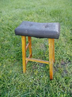 One saddle style backless barstool with cushion