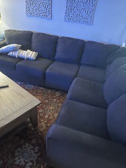 Dark charcoal sectional and rug