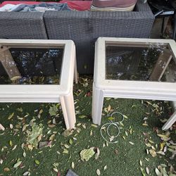 2 white glass tables