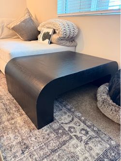 CB2 black crescent coffee table