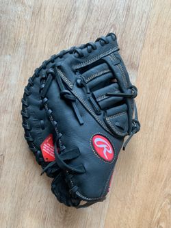 Rawlings Renegade Series First Base Mitt. It features black premium leather construction, gold accent script, distinct tan contrast stitching, and a c