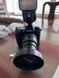 Nikon F 100 film camera with lens and flash