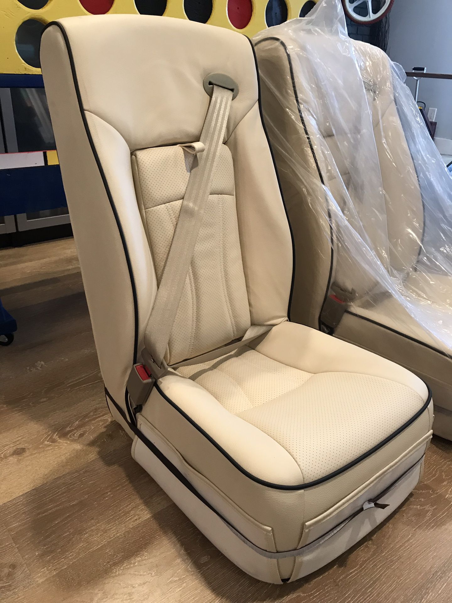 Cream color leather bus seat with built in seatbelt