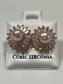 rose gold stud earrings with a central round real pearl surrounded by halo 925