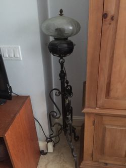 Floor lamp with glass globe wrought iron located on singer island