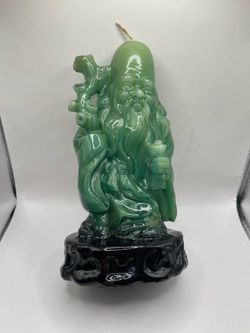 A vintage green resin or faux-jade carved figurine