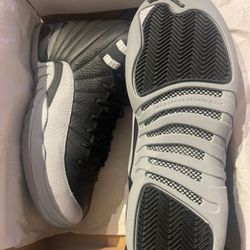 Air Jordan 12 Retro (GS) in Black/Wolf Grey in size 6.5Y, brand new, never worn.