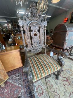 Pair of renaissance style heavily carved hall chairs