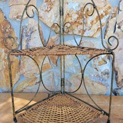 Vtg. fold up corner shelf features scrollwork wrought iron frame paired with natural wicker