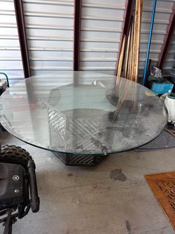 66 inch thick glass round table on Beautiful Metal stand with one small chip