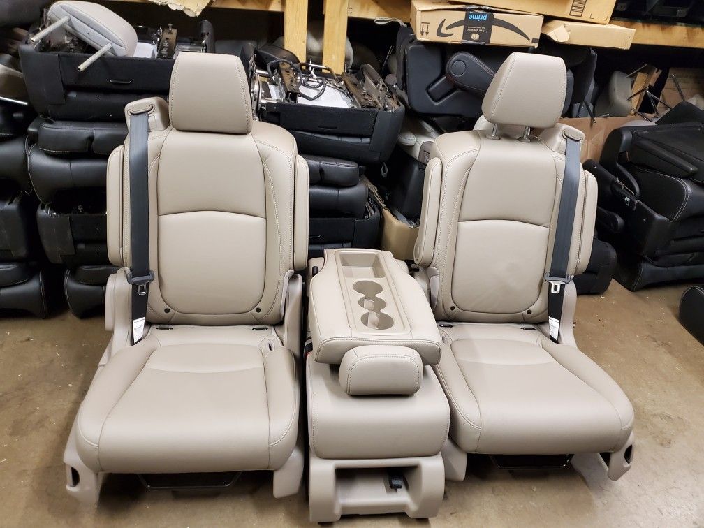 TAN LEATHER BUCKET SEATS WITH SEATBELTS AND MIDDLE SEAT 