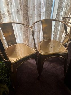 Two Gold Metal Chairs