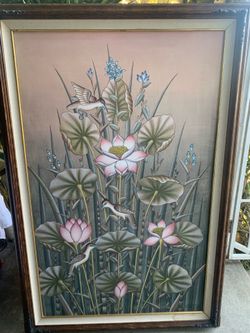 A vintage Balinese painting of lotus flowers and birds.
