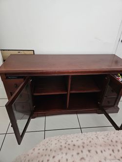 Cherry Wood TV Stand with Glass Doors and Drawers.
