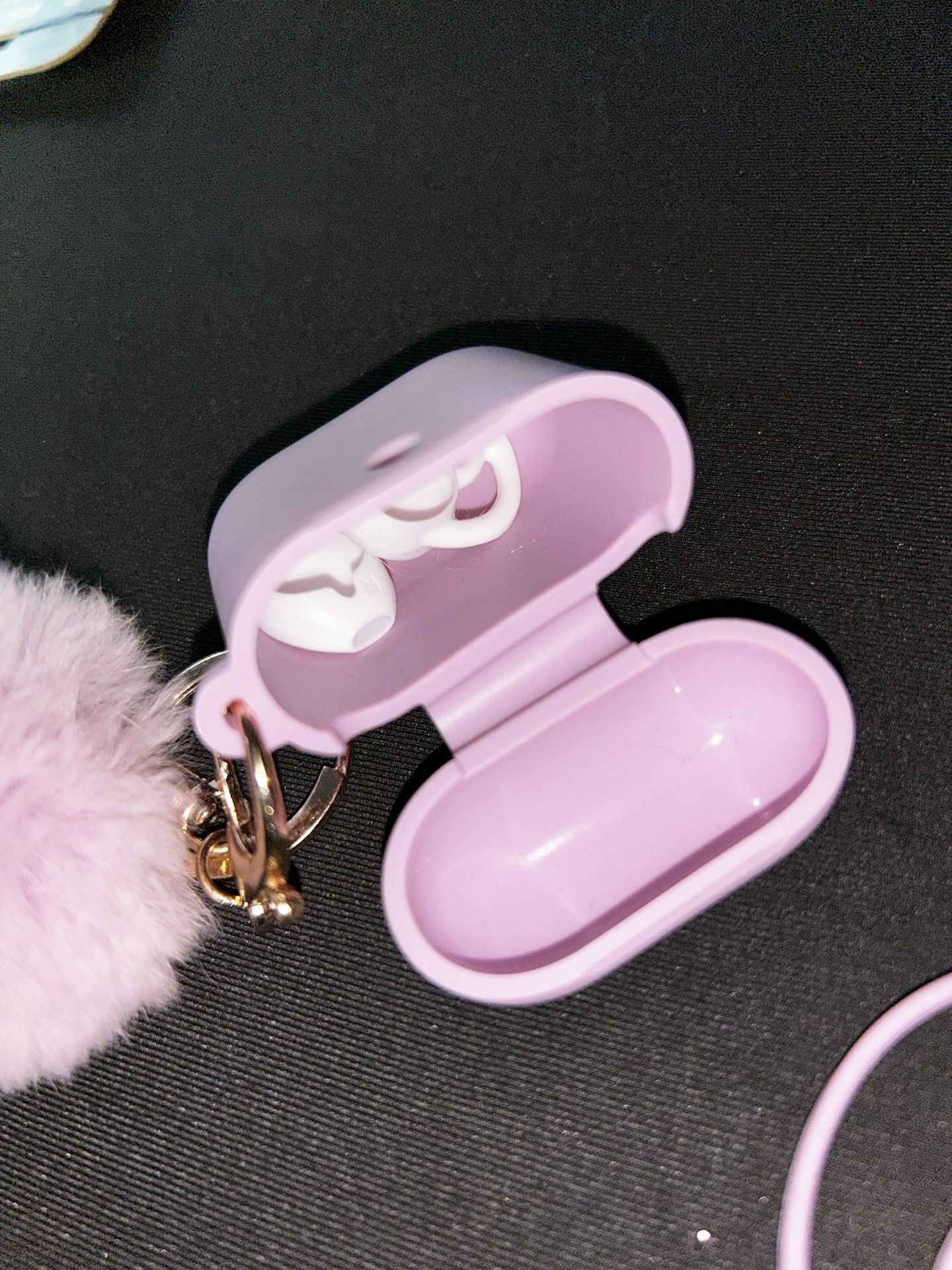 silicone case for AirPods Pro with a fluffy pom-pom keychain