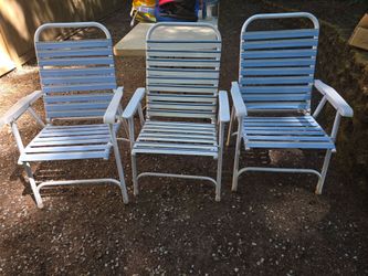 3 large lawn chairs with seat cushions.