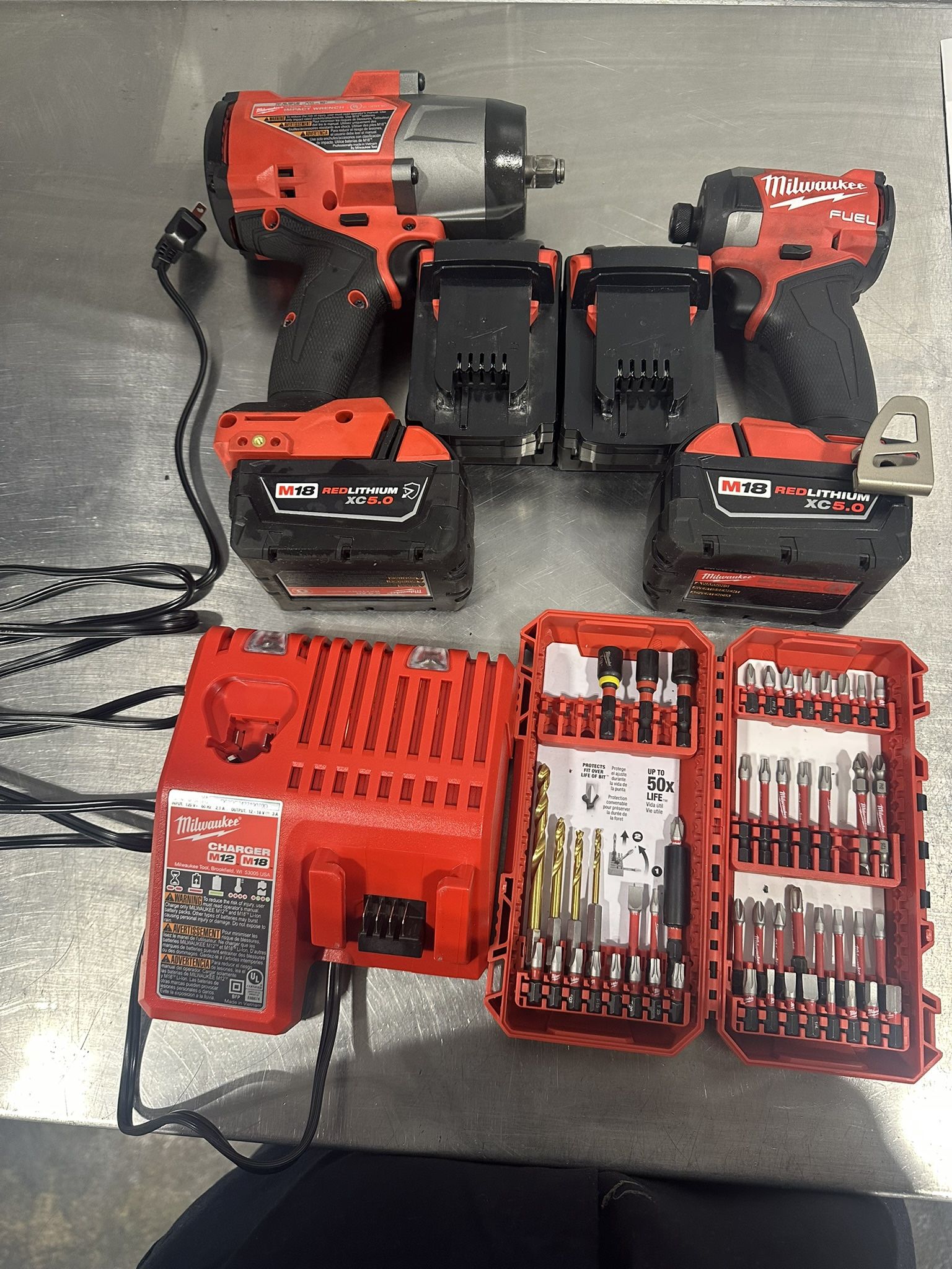 1/2 in Impact Wrench and Impact Driver. 4 batteries, charger, and but set tools box.