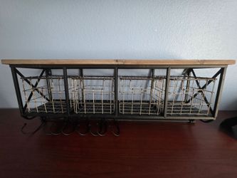Farmhouse wall shelf with metal baskets and hooks.