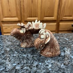 Ceramic Vintage Moose and Cow Pair of Salt and Pepper shakers.  Size approximately Moose 3 inches tall.  Preowned no stoppers.  