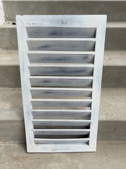 rectangular wooden louvered vent or architectural gable louver with a distressed white and gray finish