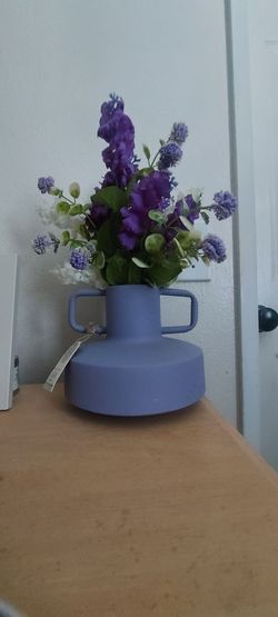 Purple vase with fake flowers