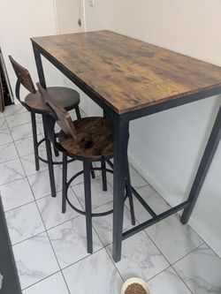 Industrial-style bar table and two stools