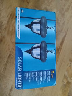 two outdoor hanging solar coach lights