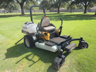 Cub cadet commercial tank zero turn mower equipped with a ride on sprayer attachment