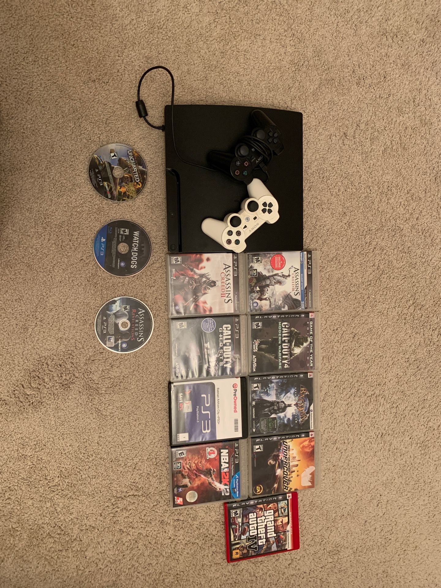 PS3 console (w/ 2 controllers, controller charging wire, and 12 PS3 games)