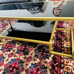 Black and gold glassy coffee table