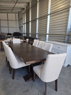 Erma Dining Table and 8 Chairs
Constructed from Oak Veneers with Rubberwood Solids
Stain Resistant Fabric on Chairs
16-inch Self-Storing Leaf
Adjustab