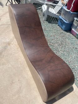 Brown feaux leather chaise lounge style chair