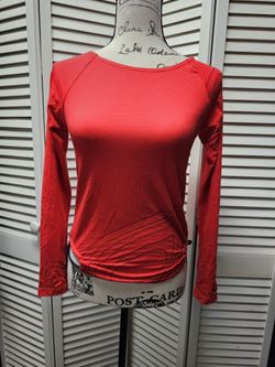 Nike pretty red long sleeve top athletic type top with black stitching and adjustable tie sides