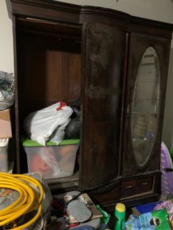 vintage wooden wardrobe with two drawers at the bottom.
