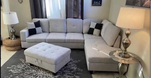 Gray linen sectional couch and ottoman