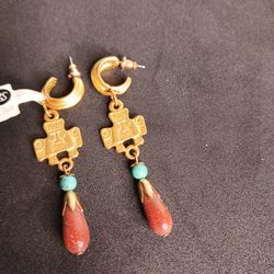 Gold-tone Southwestern dangle earrings featuring an Andean/Inca Cross (Chakana) charm with turquoise accent bead and red teardrop stone. Hoop-style ea