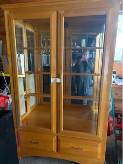 Armoire glass cabinet with shelves and a light