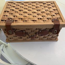 Wicker picnic basket with plates and utensils