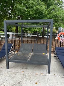 heavy-duty commercial-style double chaise loungers (metal frames with canopy)