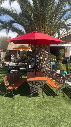 Five-piece set: two benches, a table with a base, and an umbrella.