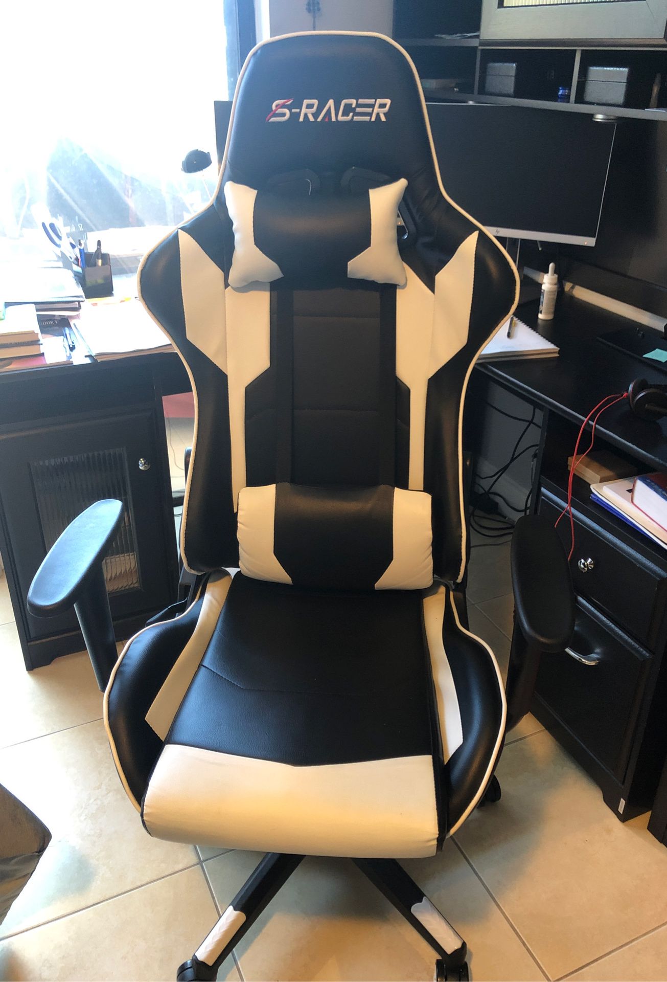 Black and white computer gaming chair S-racer like new, used once. Lean back function and neck and back pillow for ergonomic feel.