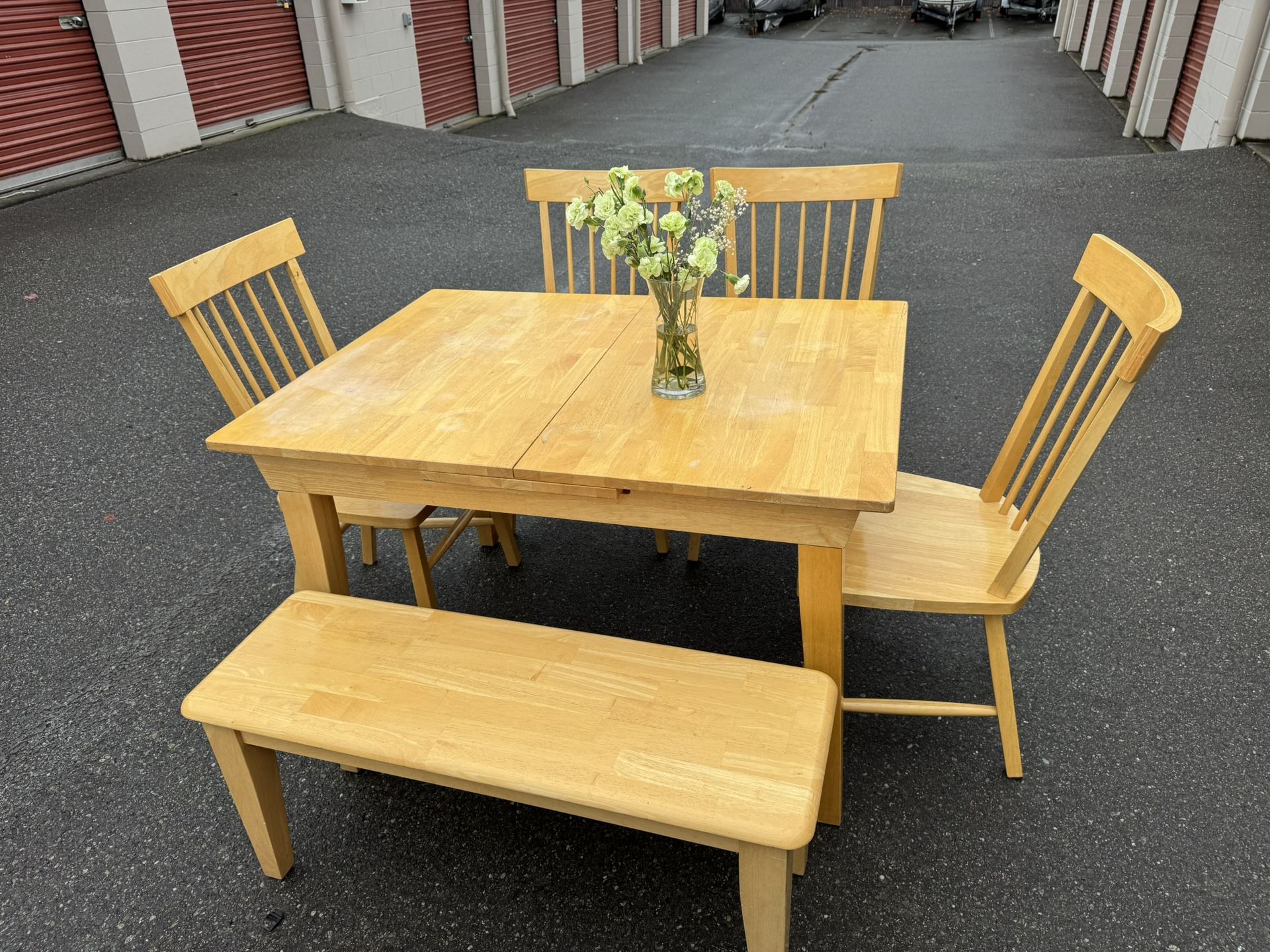 Wooden table and four chairs and a bench