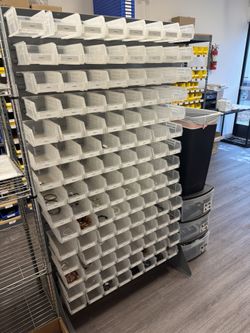 Double Sided Floor Rack Bin Organizer with 7 1⁄2 x 4 x 3" Clear Bins. 120 Bins Each Side